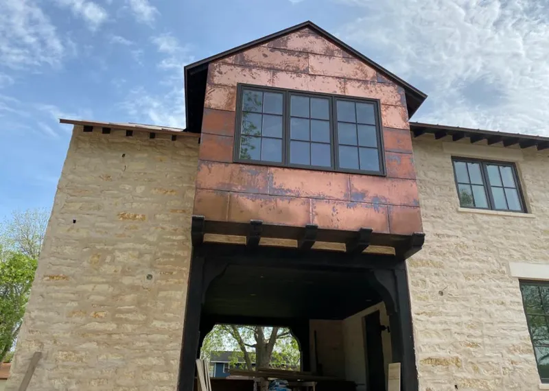 Copper metal panel facade on a stone building for Skylight Installation in Wrentham
